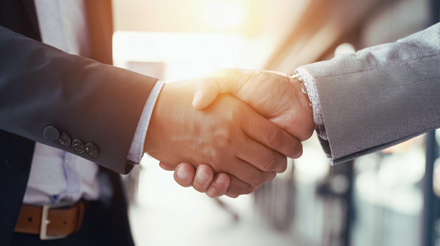 Geschaeftsmann-Handshake-fuer-Teamarbeit-–-Geschaeftsfusions-und-Uebernahmekonzept